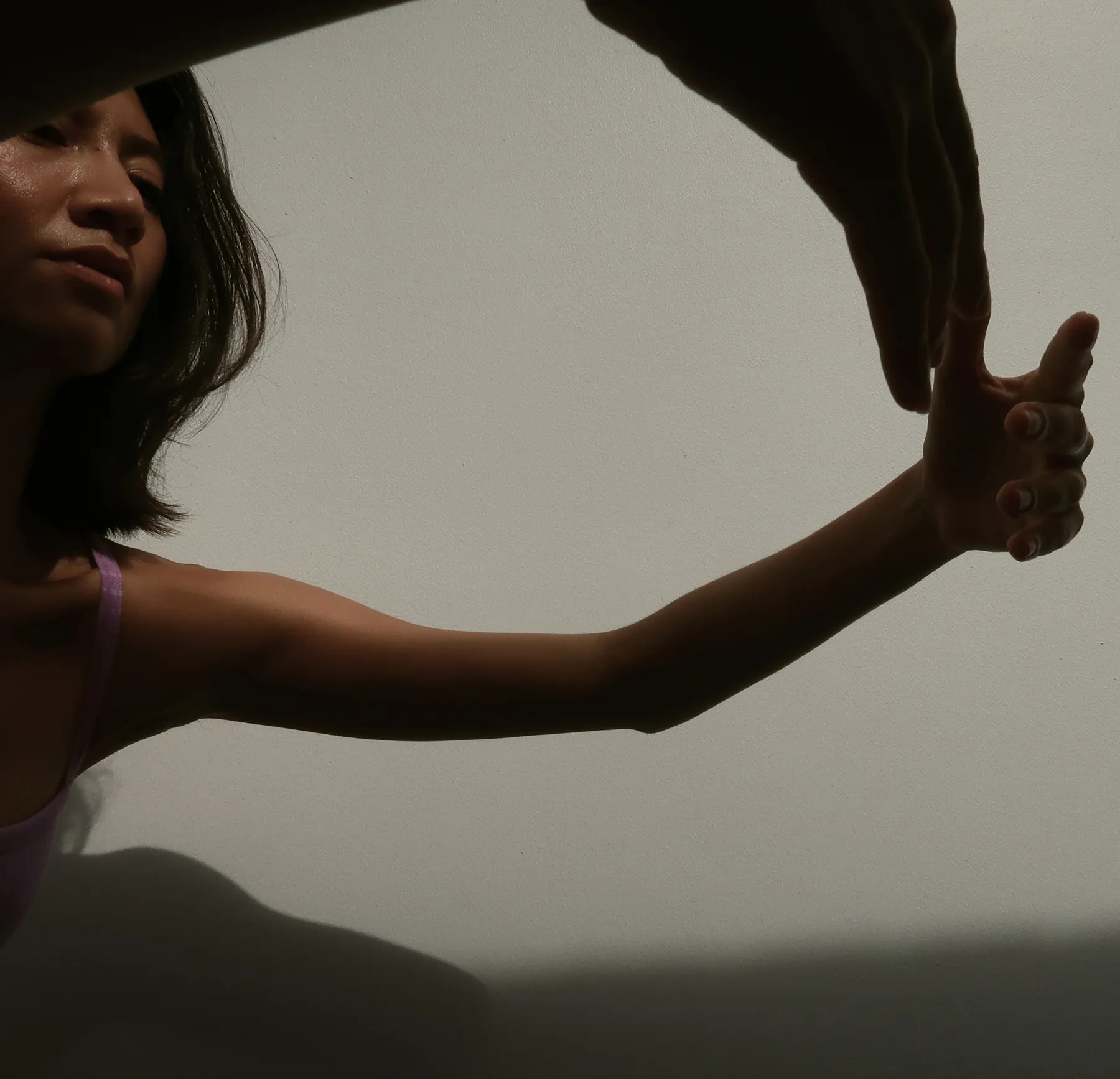 Dancer arching backward in front of a studio window