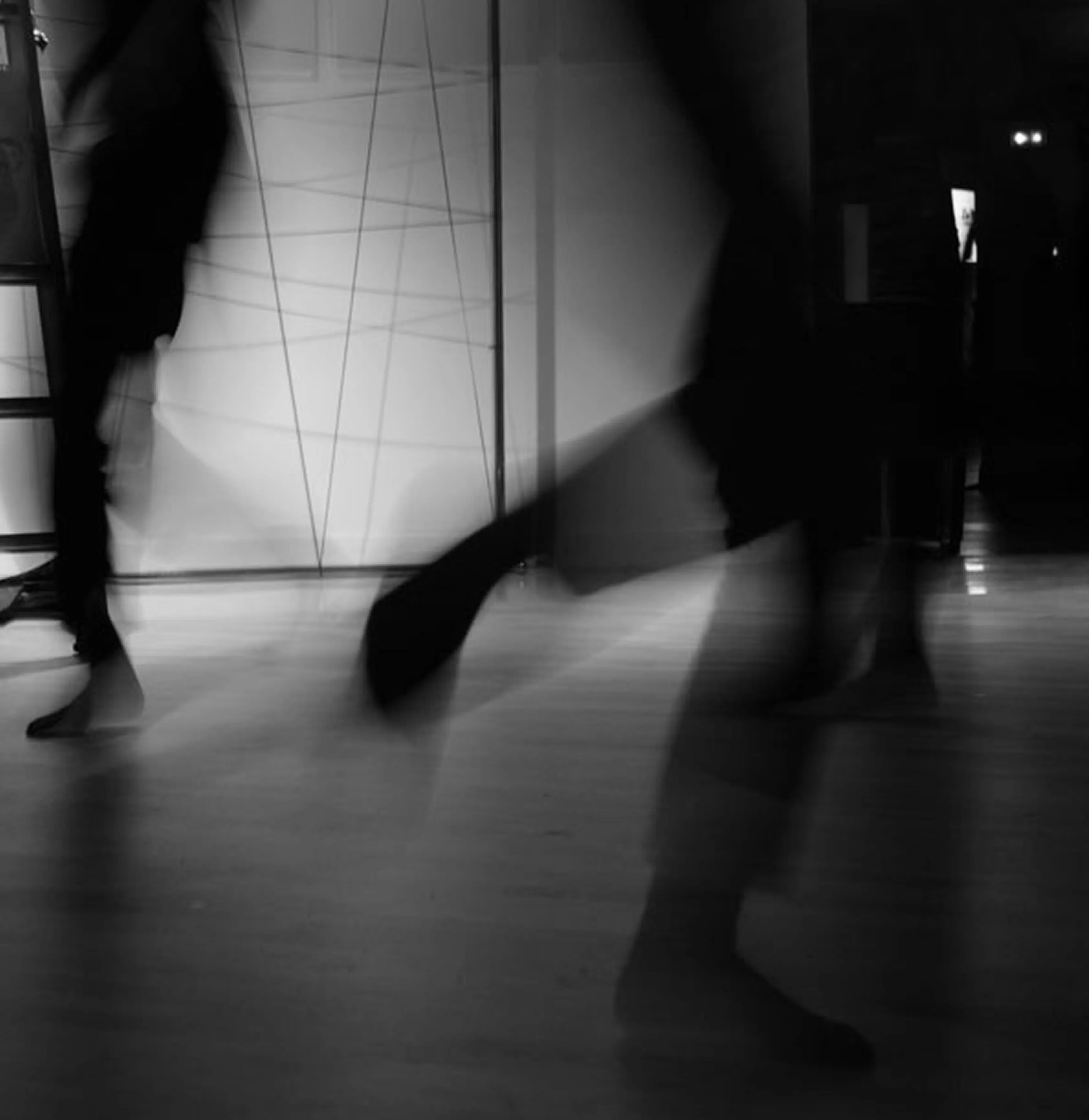 Blurred dancers moving through a studio