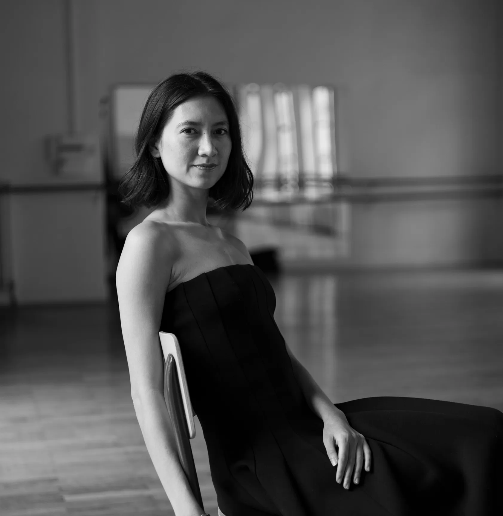 Mytam seated in a black dress in the studio