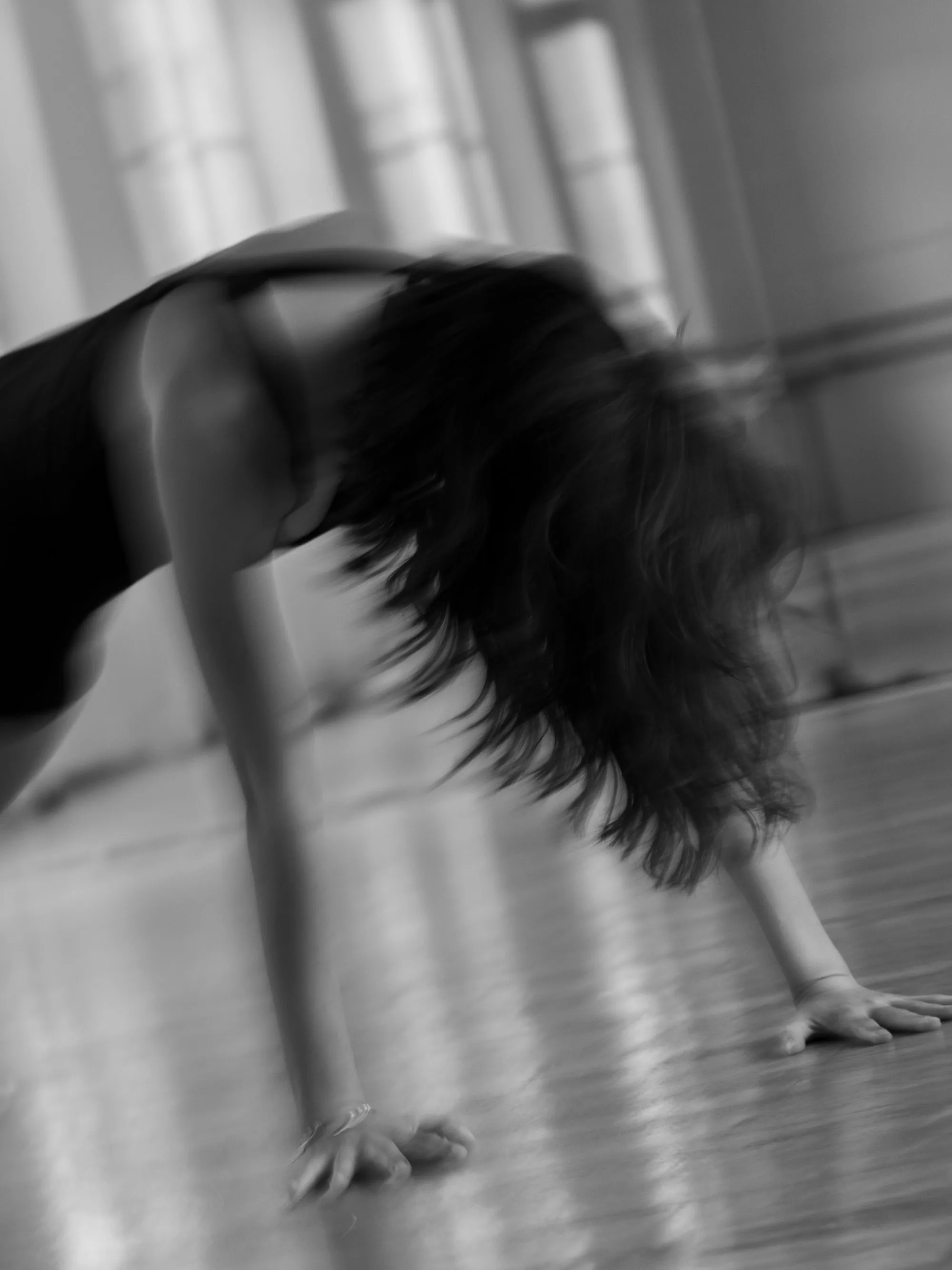 Mytam in motion in the studio, hands on the floor